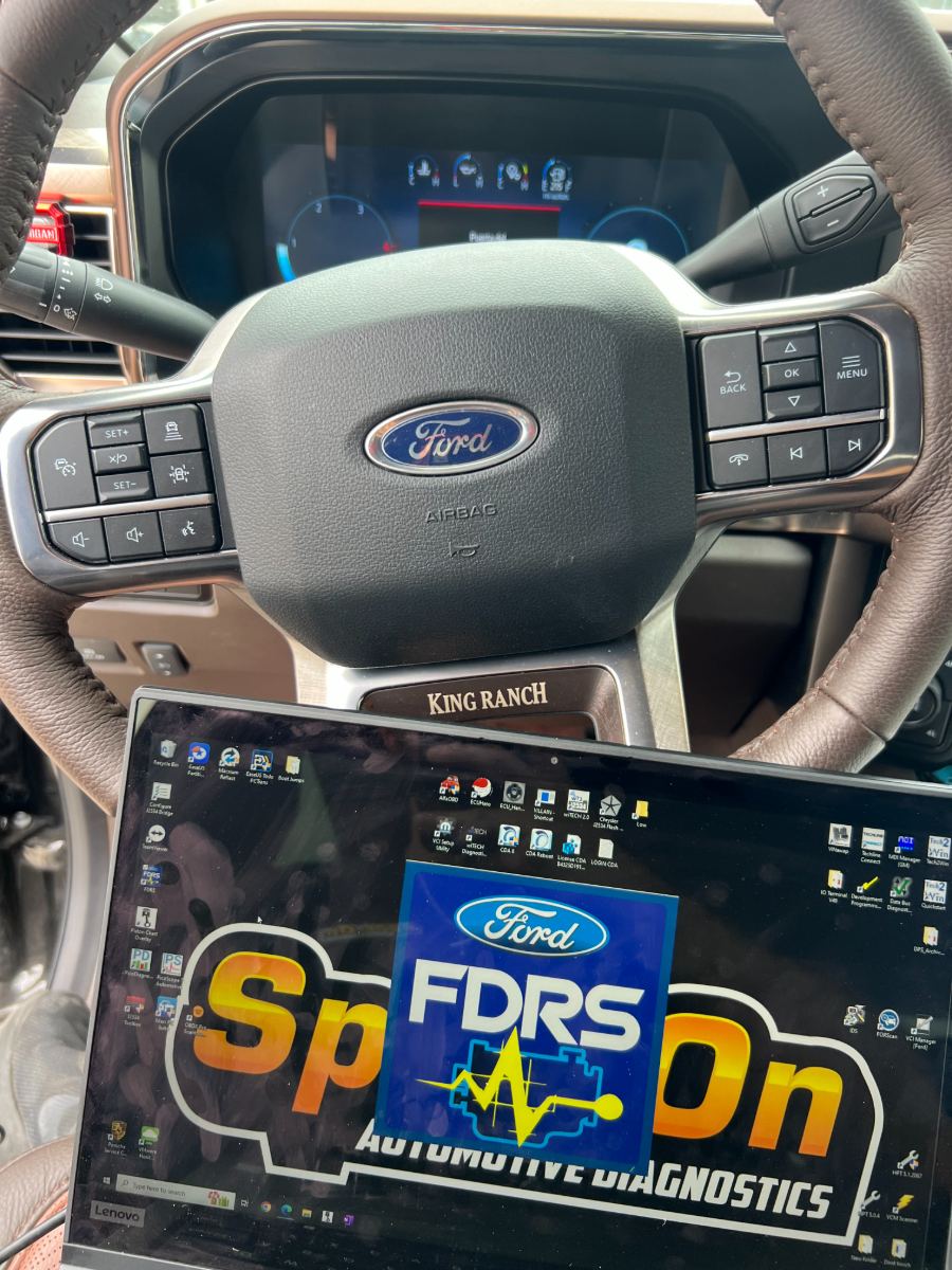 Ford F-150 King Ranch steering wheel with FDRS programming software open on a connected Lenovo diagnostic laptop